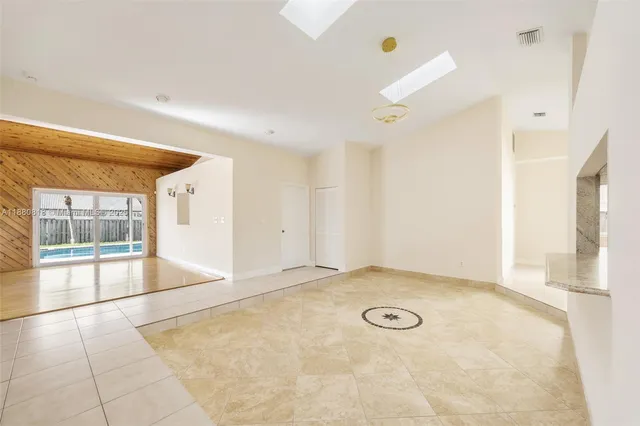 an empty room with a empty space and windows