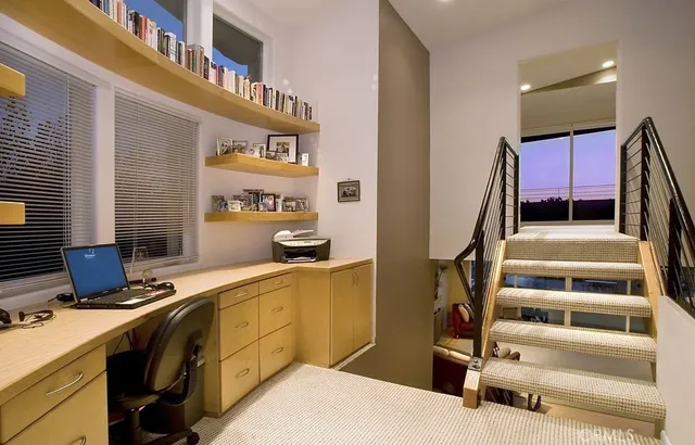 a bathroom with a granite countertop sink a toilet and a mirror
