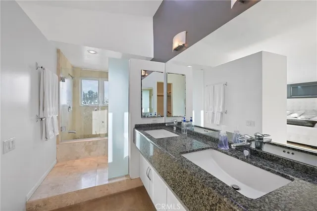 a bathroom with a glass shower door and a shower