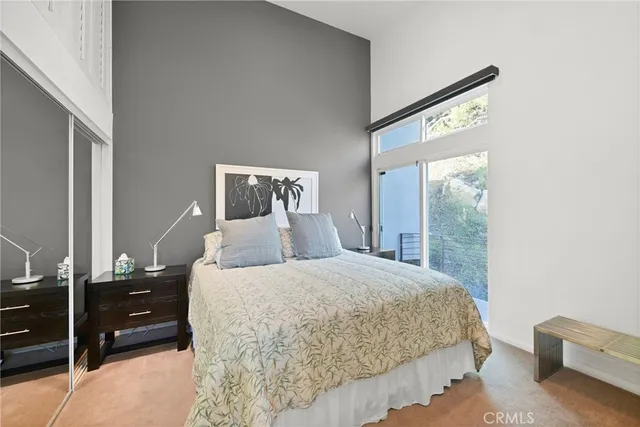 a bedroom with a large bed and a chandelier