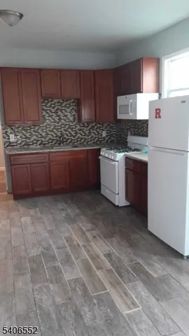 a kitchen with stainless steel appliances a refrigerator sink and cabinets