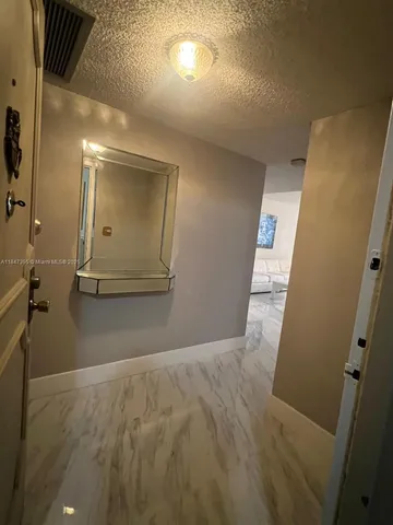 a kitchen with kitchen island granite countertop a sink cabinets and stainless steel appliances