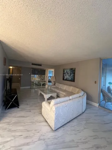 a spacious bedroom with a bed and a couch