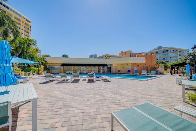 a view of a patio with table and chairs under an umbrella