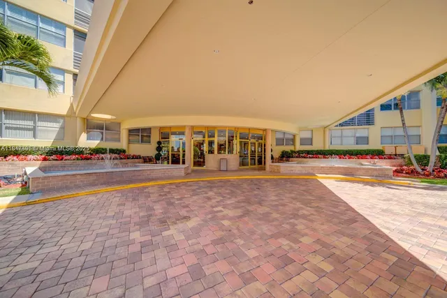 a view of building with cars parked