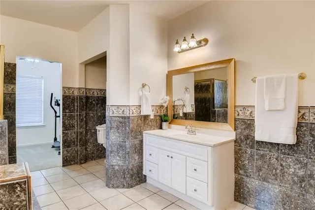 a bathroom with a sink a mirror and a shower