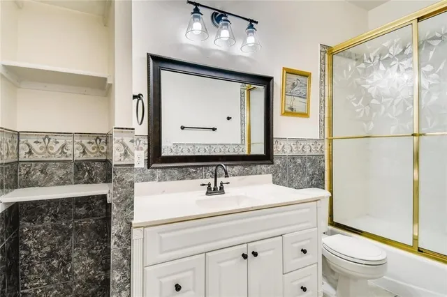 a bathroom with a sink a toilet and a mirror