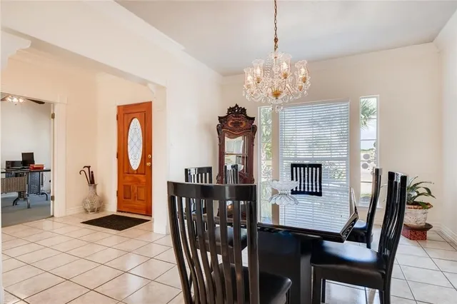 a view of a dining room with furniture and chandelier