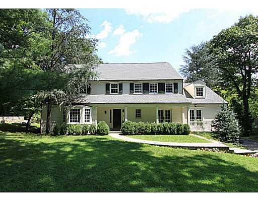 49 Pecksland Road Greenwich, CT 06831 - Photo 1 of 18 a front view of a house with a garden