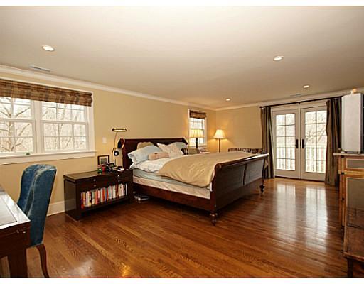 49 Pecksland Road Greenwich, CT 06831 - Photo 8 of 18 a spacious bedroom with a bed a couch and large windows