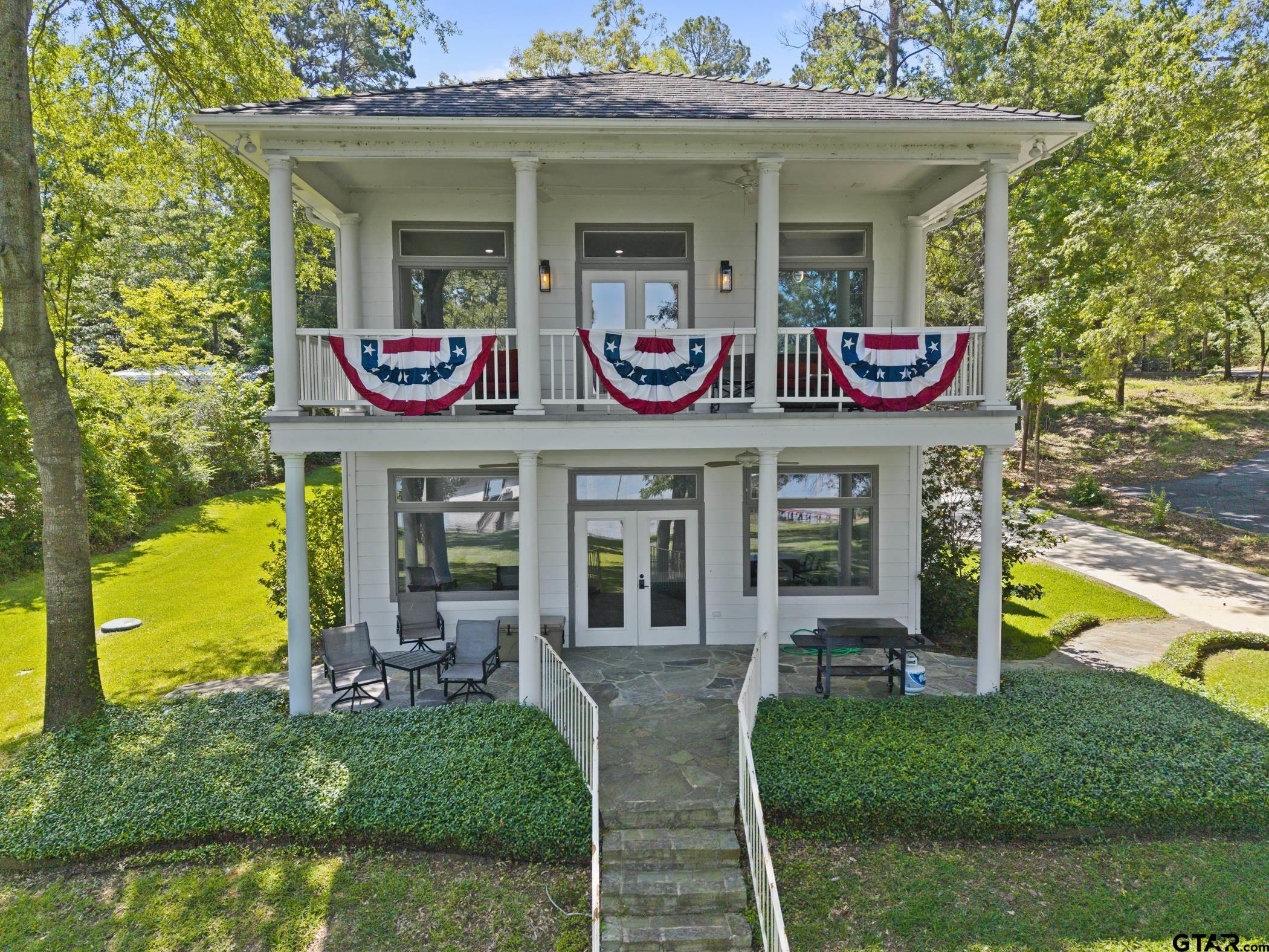 18630 Eastside Road Troup, TX 75789 - Photo 1 of 47 a front view of a house with garden and patio