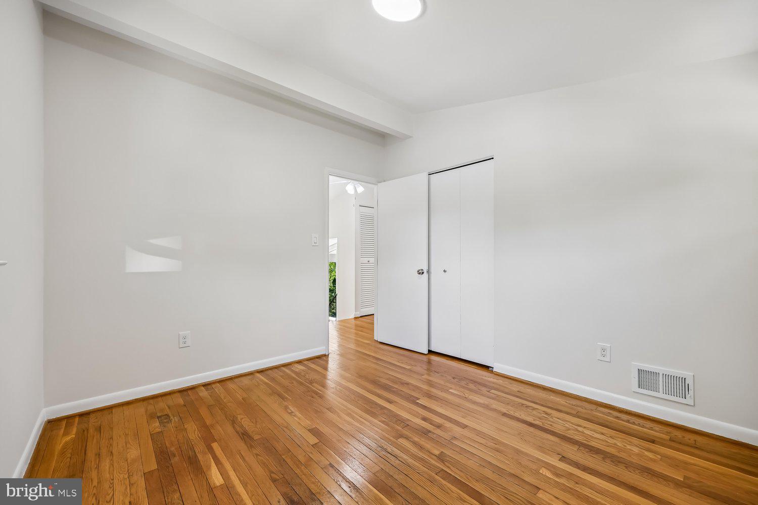 300 Gilsan Court Silver Spring, MD 20902 - Photo 79 of 117 a view of an empty room with wooden floor