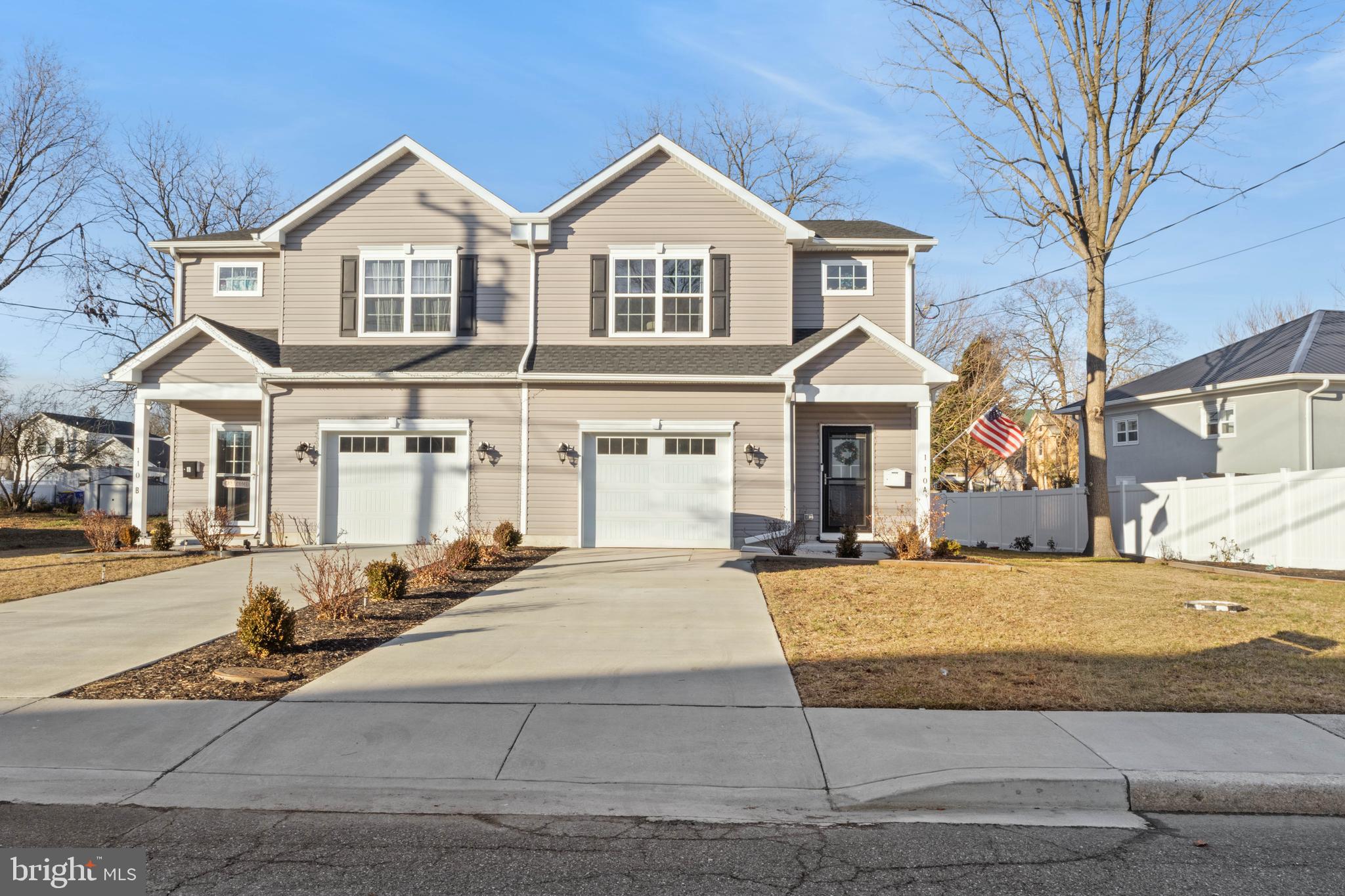 a front view of a house with yard and parking