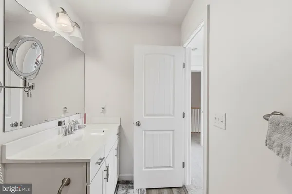 a spacious bathroom with a double vanity sink and a mirror