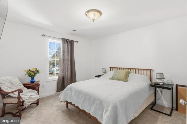 a bedroom with a bed and window