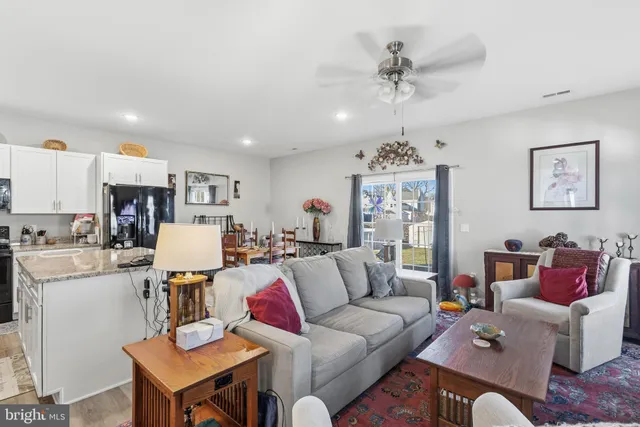 a living room with furniture and kitchen view