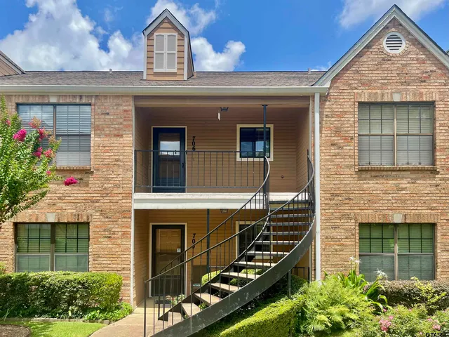 a front view of a house with plants