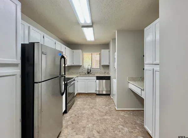 a kitchen with a refrigerator a sink and dishwasher