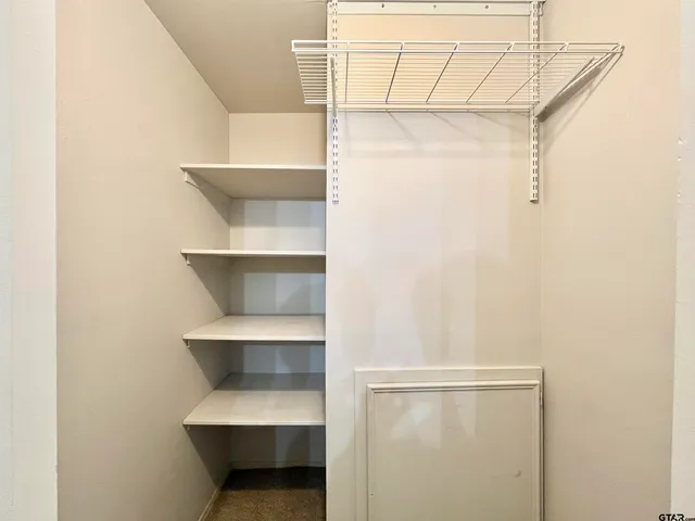 a hallway view with staircase