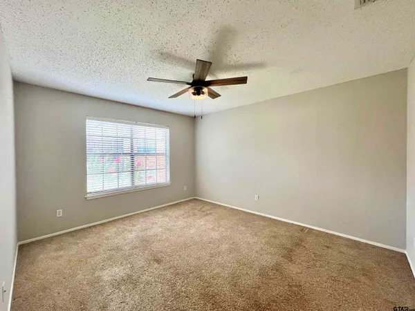 a view of a livingroom with a ceiling fan and window