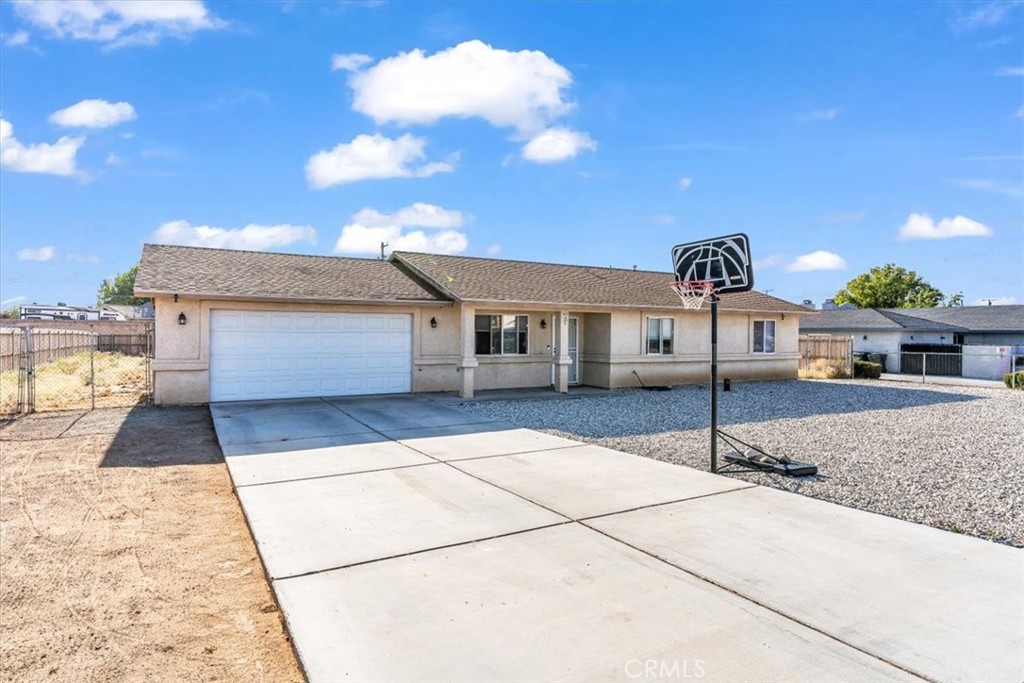 13146 Mohawk Road Apple Valley, CA 92308 - Photo 1 of 15 a front view of a house with a yard