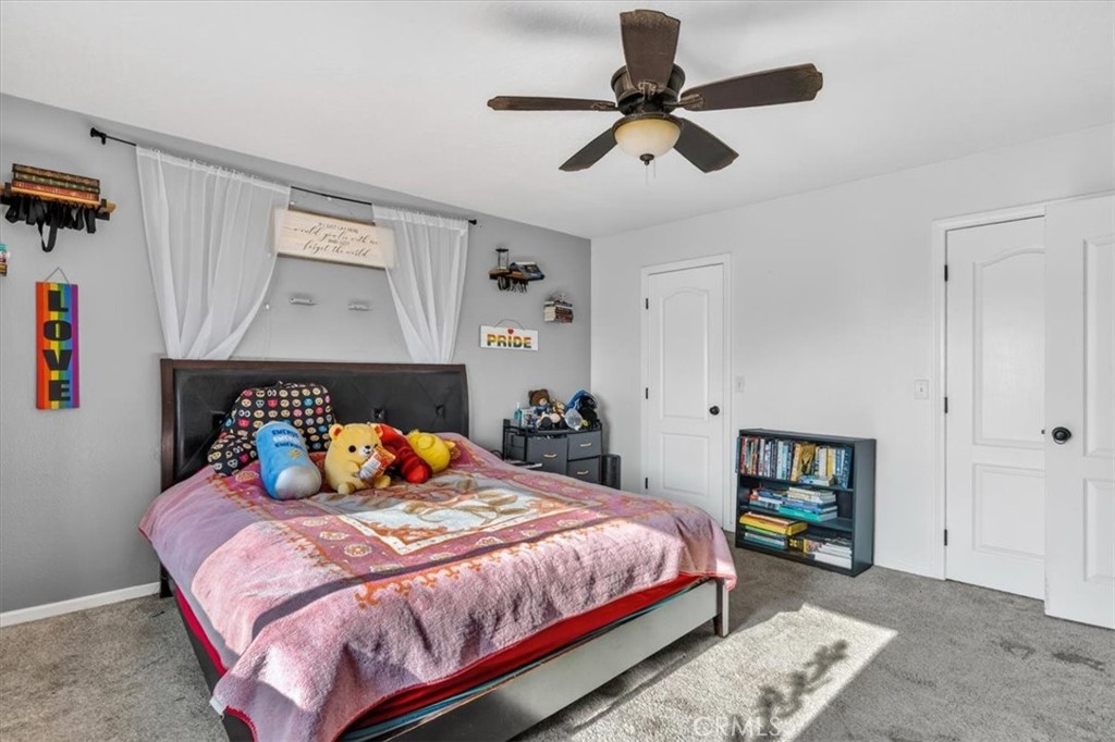 13146 Mohawk Road Apple Valley, CA 92308 - Photo 11 of 15 a bedroom with a bed a dresser and a book shelf