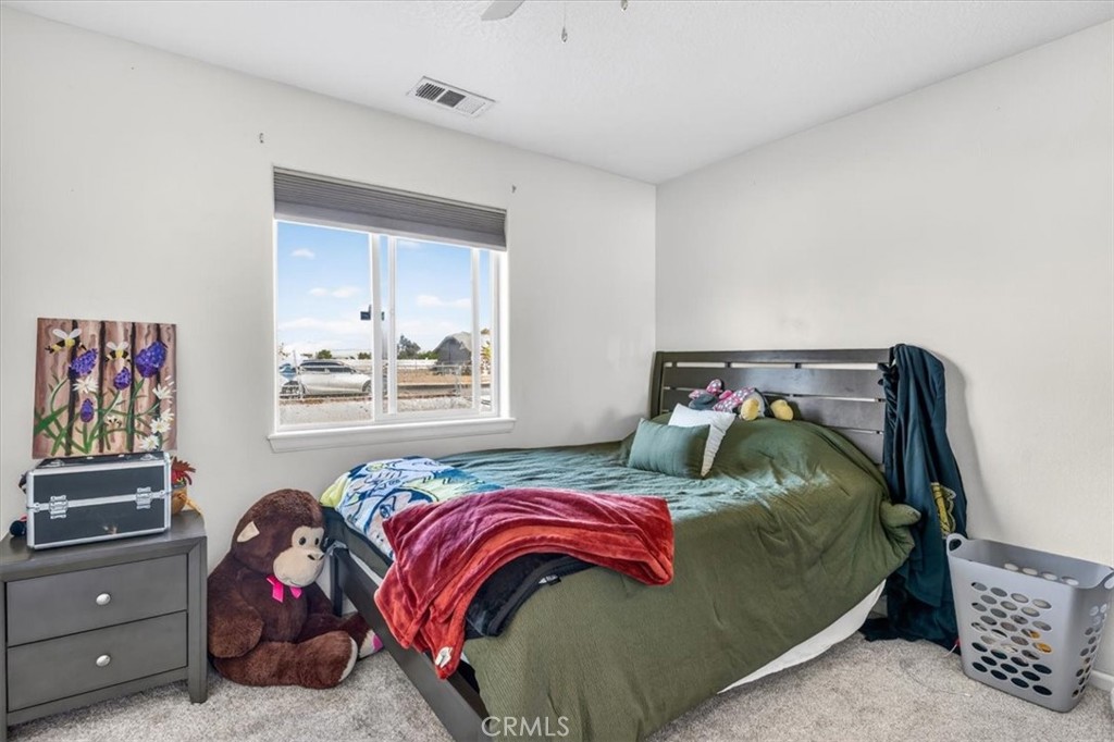 13146 Mohawk Road Apple Valley, CA 92308 - Photo 13 of 15 a bedroom with a bed and a window