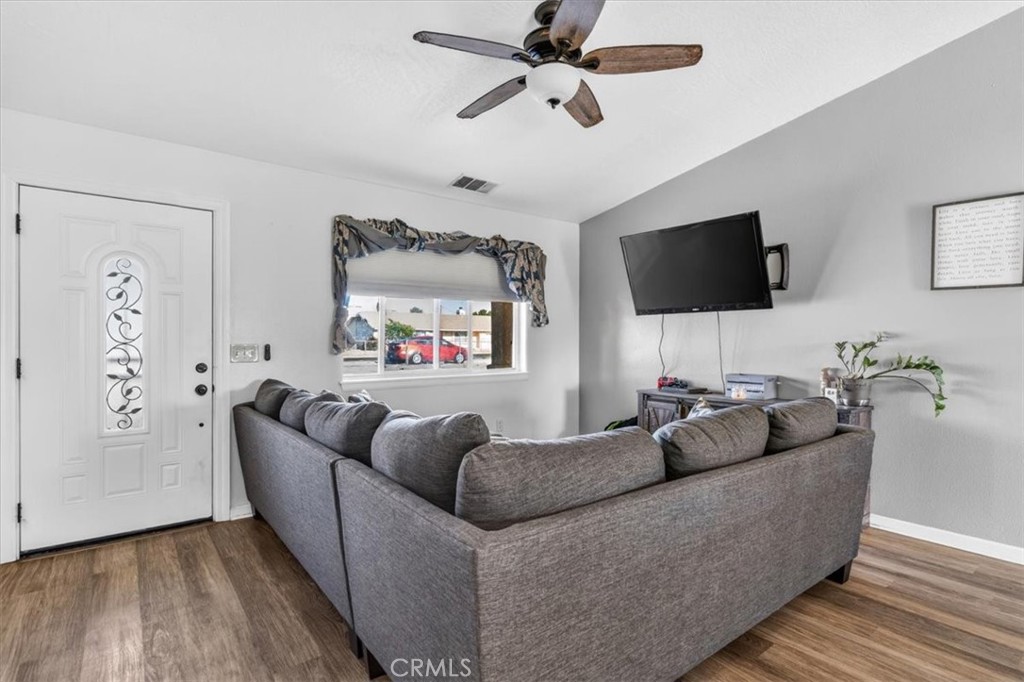 13146 Mohawk Road Apple Valley, CA 92308 - Photo 2 of 15 a living room with furniture and a flat screen tv