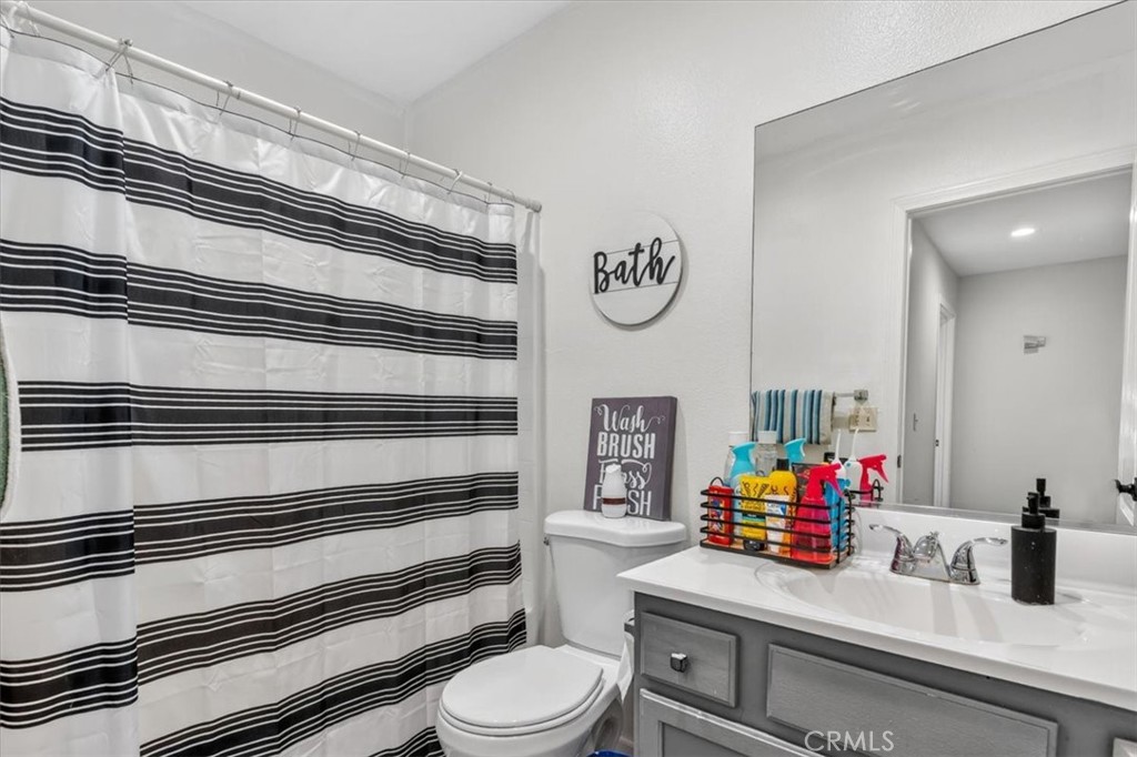 13146 Mohawk Road Apple Valley, CA 92308 - Photo 10 of 15 a bathroom with a toilet and a sink
