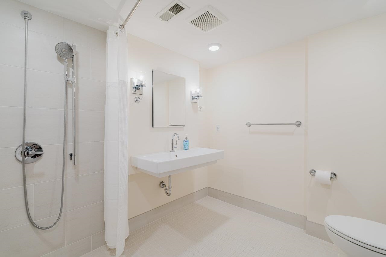 3881 Davis Road Penn Laird, VA 22846 - Photo 60 of 75 a bathroom with a granite countertop sink a toilet and shower