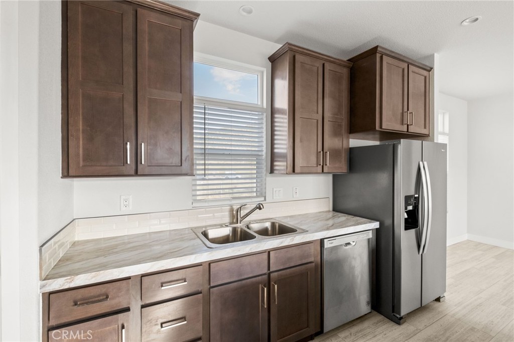 26220 Calvert Avenue Hemet, CA 92545 - Photo 33 of 69 a kitchen with stainless steel appliances granite countertop a refrigerator and a sink