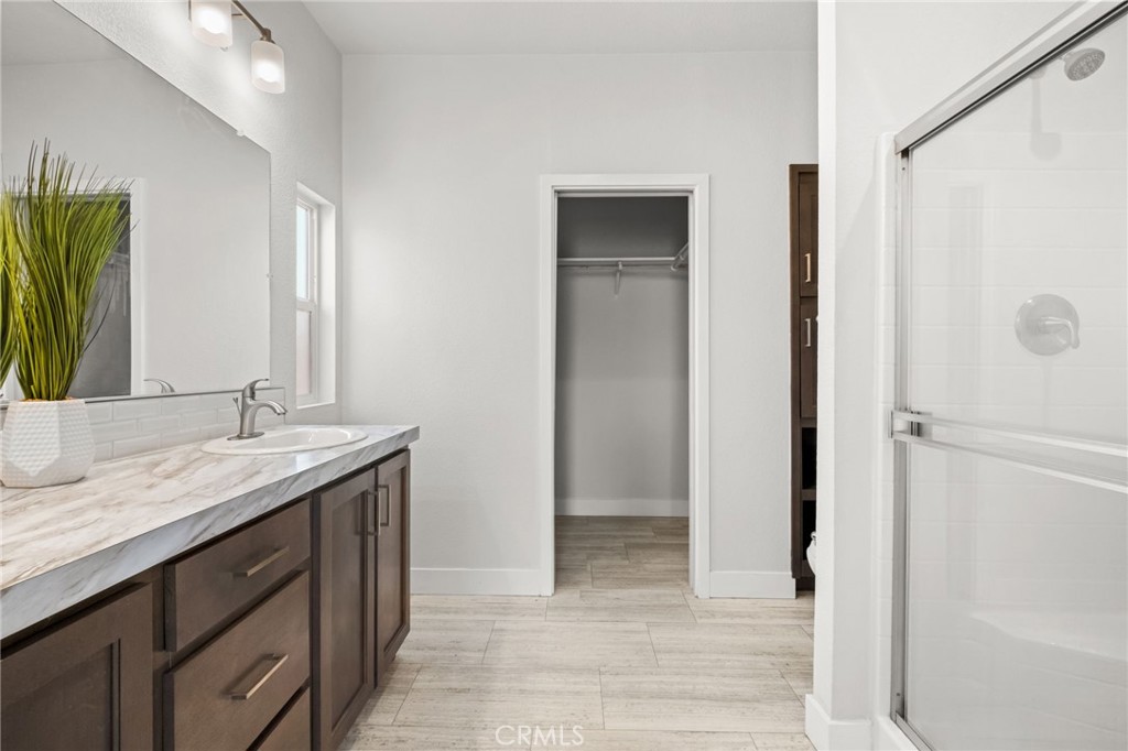 26220 Calvert Avenue Hemet, CA 92545 - Photo 36 of 69 a bathroom with a granite countertop sink and a mirror
