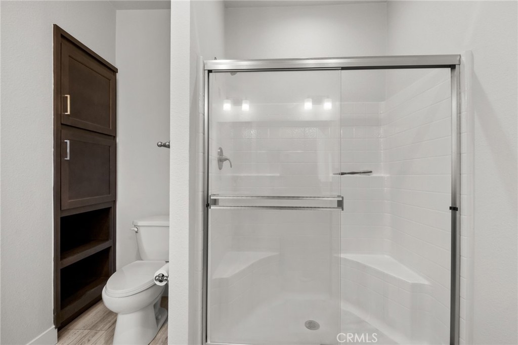 26220 Calvert Avenue Hemet, CA 92545 - Photo 38 of 69 a bathroom with a shower and a toilet