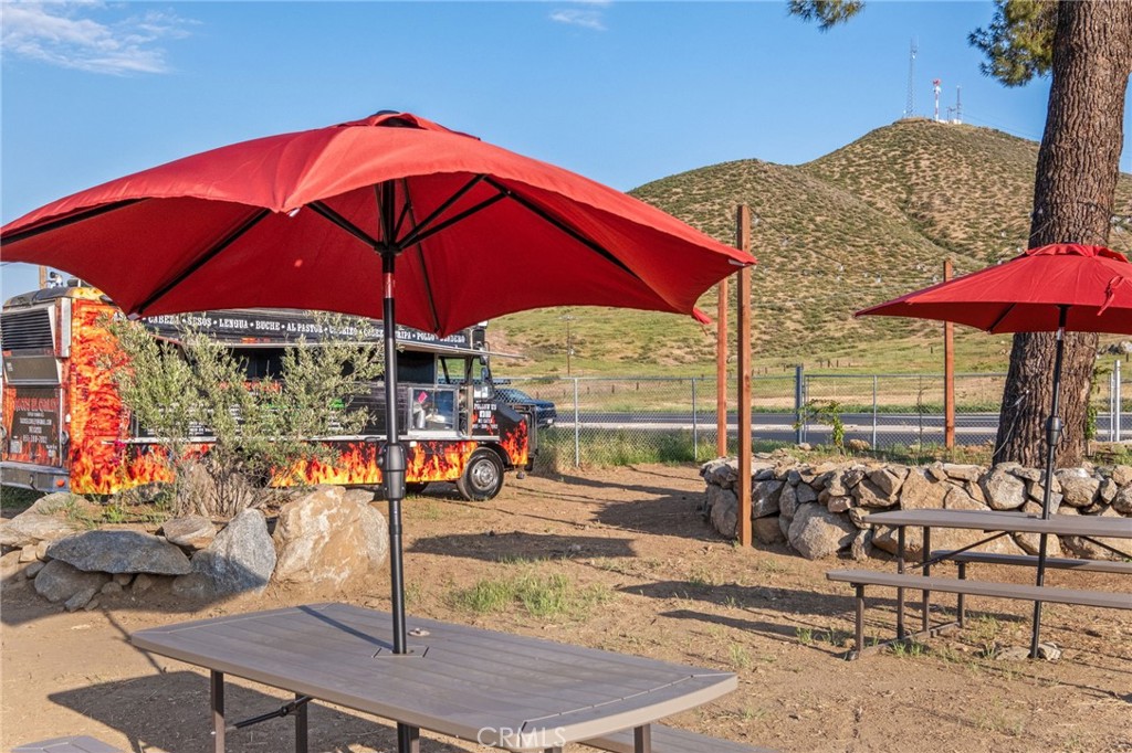 26220 Calvert Avenue Hemet, CA 92545 - Photo 48 of 69 a view of a patio with a table and chairs under an umbrella