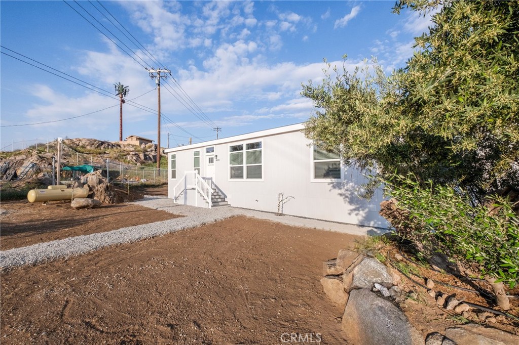 26220 Calvert Avenue Hemet, CA 92545 - Photo 63 of 69 a view of a house with a tree and a yard
