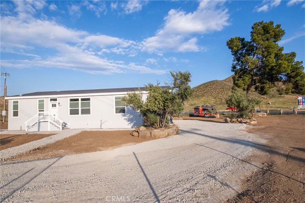 26220 Calvert Avenue Hemet, CA 92545 - Photo 69 of 69 a view of a house with a backyard and a garage
