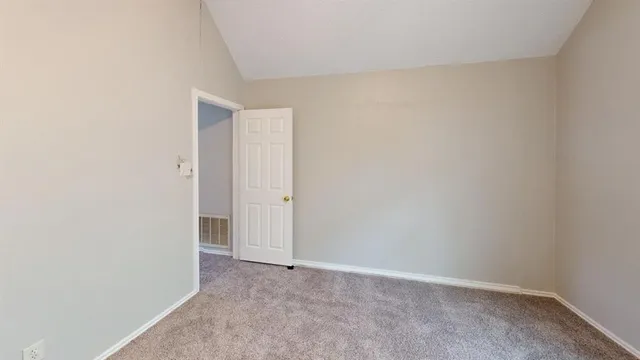 an empty room with windows and chandelier