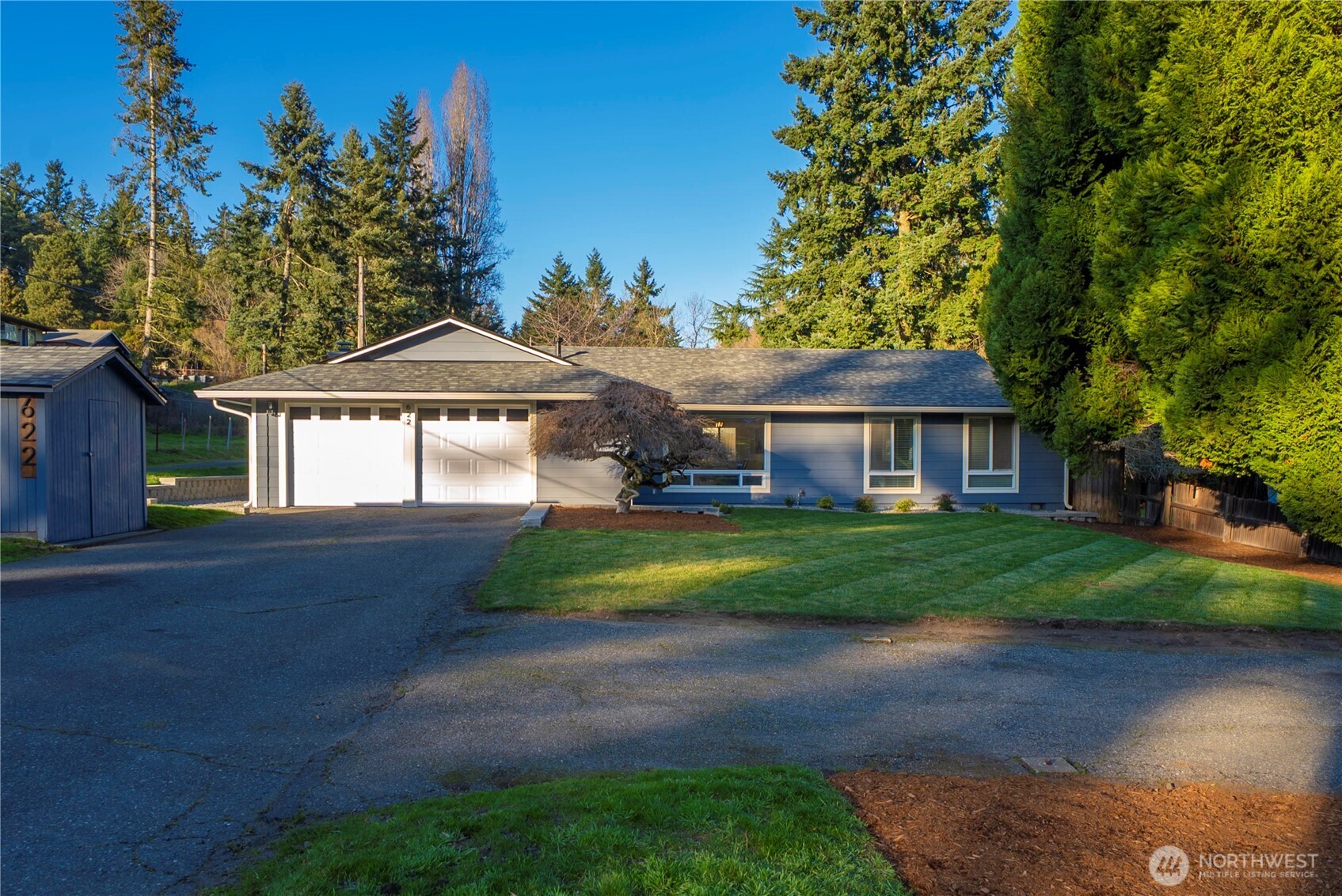 a front view of a house with yard and green space