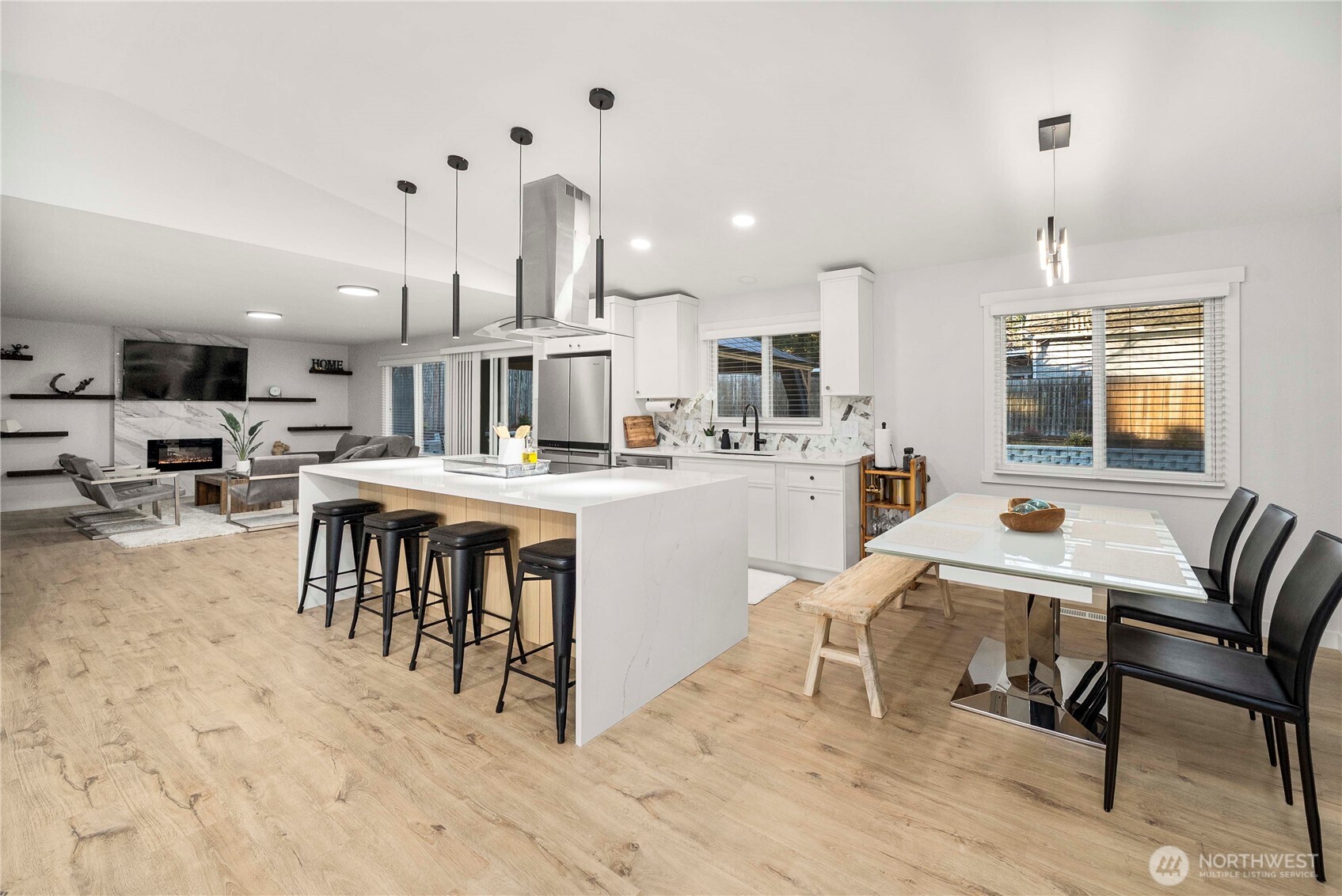 622 South 150th Street Burien, WA 98148 - Photo 3 of 25 a kitchen with kitchen island a dining table chairs stainless steel appliances and cabinets
