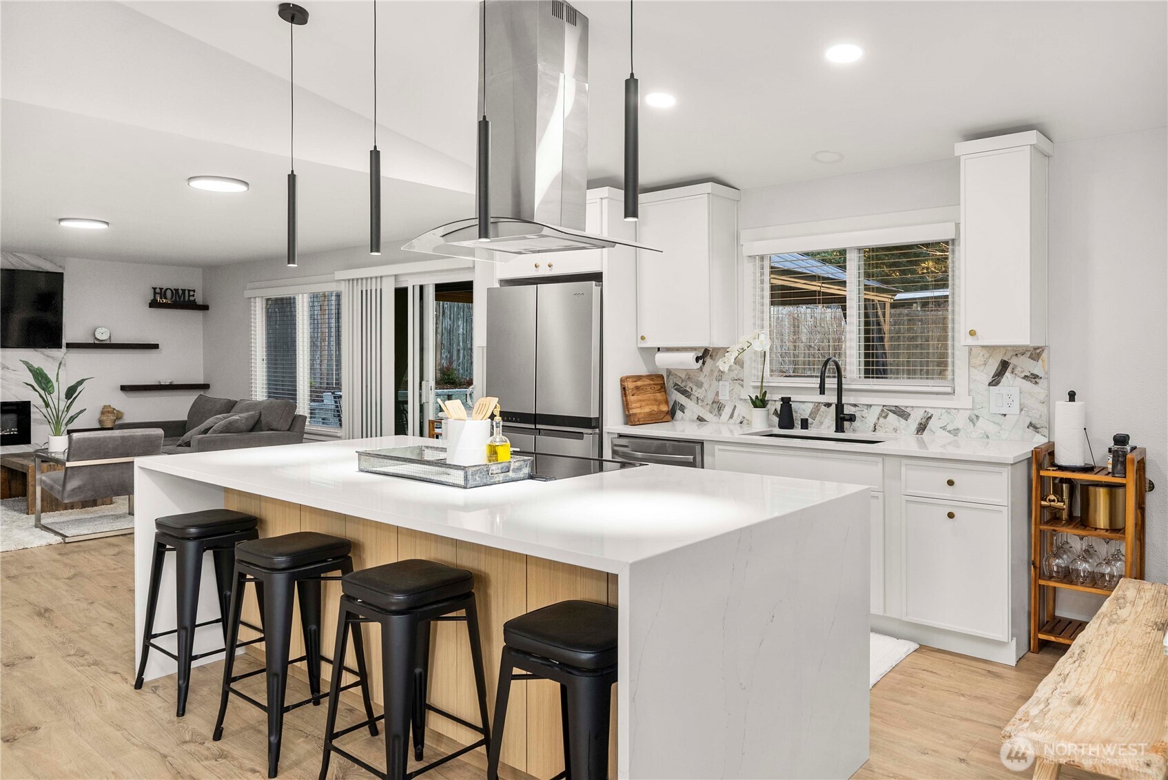 622 South 150th Street Burien, WA 98148 - Photo 4 of 25 a kitchen with stainless steel appliances kitchen island a table and chairs in it