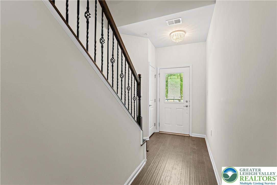 4758 Rafi Road Easton, PA 18045 - Photo 40 of 55 A graceful staircase with ornate wrought iron railings complements the inviting entry with hardwood flooring and an overhead light fixture.