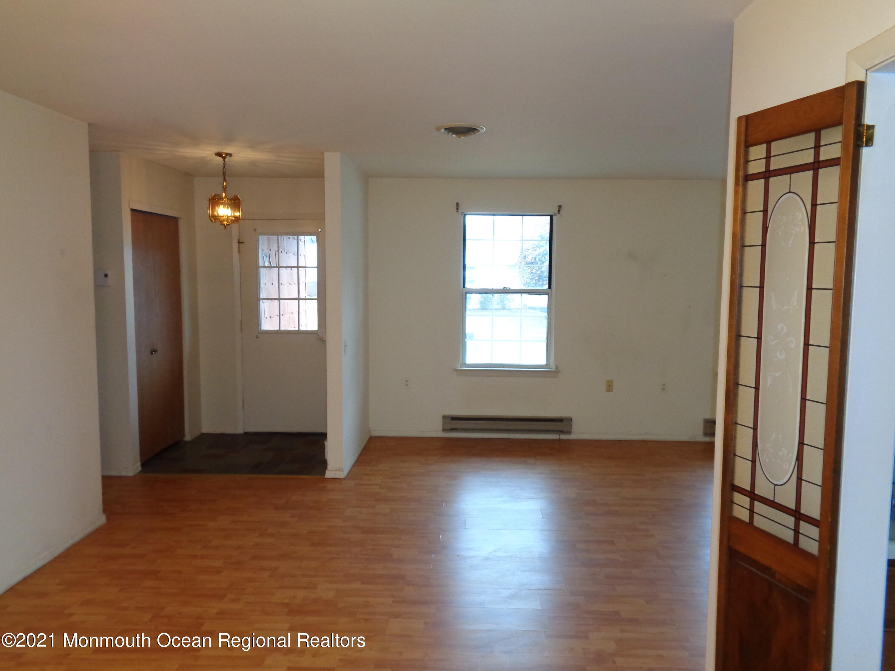 5 Amesbury Road Whiting, NJ 08759 - Photo 4 of 19 an empty room with wooden floor and windows
