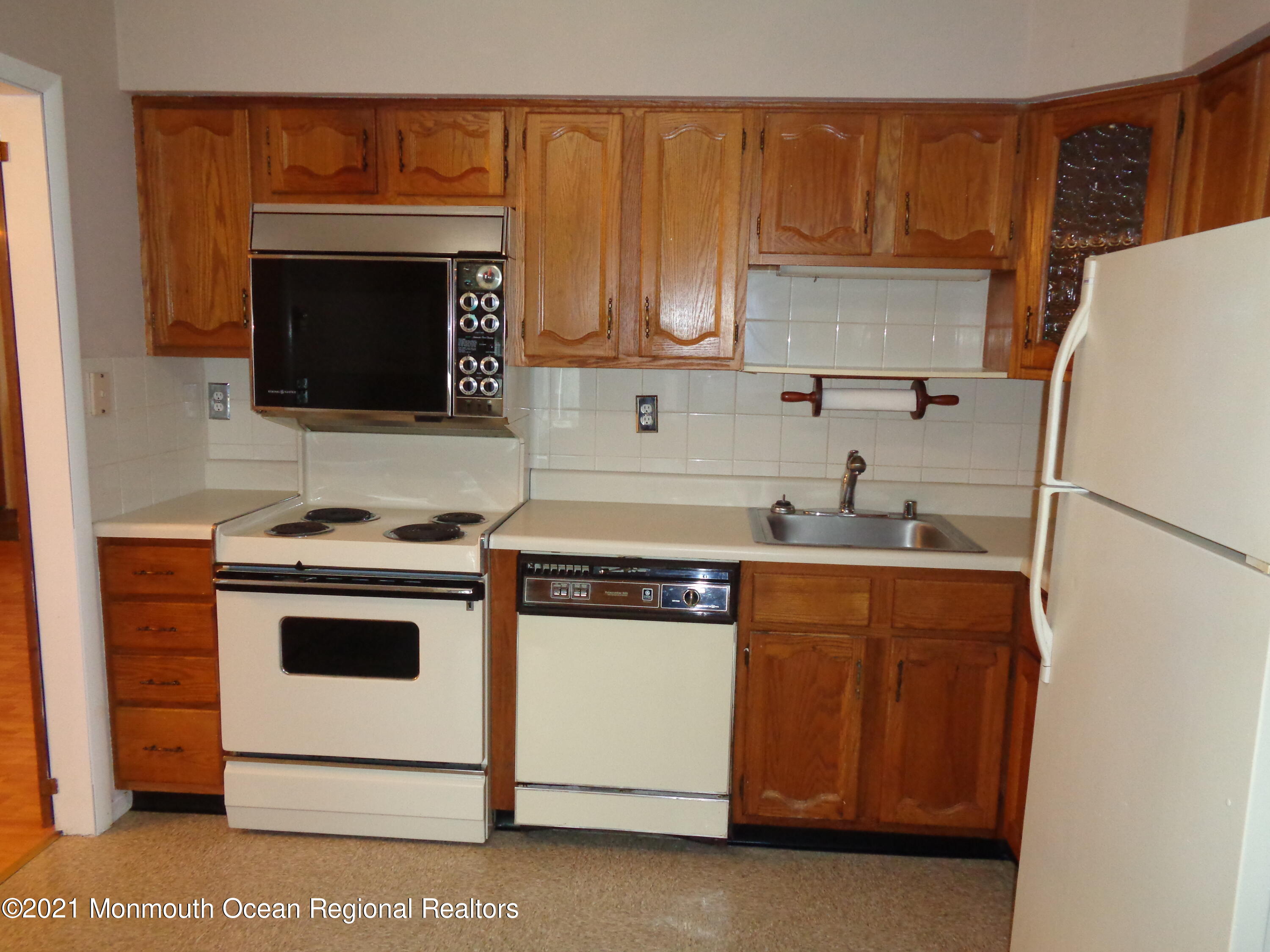 5 Amesbury Road Whiting, NJ 08759 - Photo 6 of 19 a kitchen with stainless steel appliances a stove a microwave and a sink