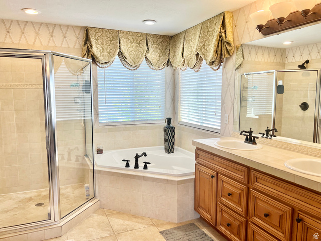 369 Culross Circle Tooele, UT 84074 - Photo 25 of 54 Corner soaking tub with a tiled surround, framed by a window with custom valances