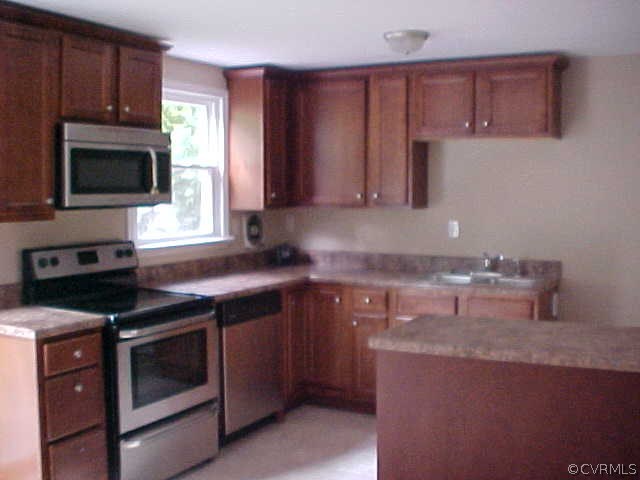 9305 Cason Road Glen Allen, VA 23060 - Photo 11 of 12 a kitchen with a stove microwave and sink