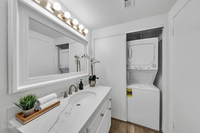 a bathroom with a double vanity sink and a mirror