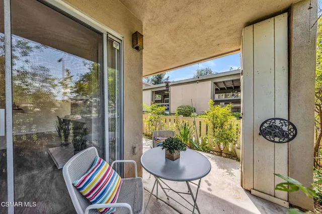 a balcony with table and chairs