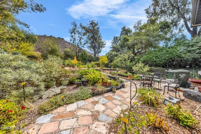a view of a patio with table and chairs and potted plants