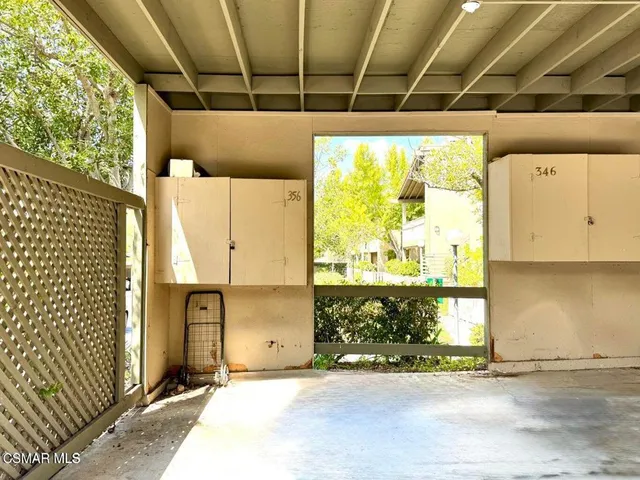 a view of a garage with wooden floor and a window