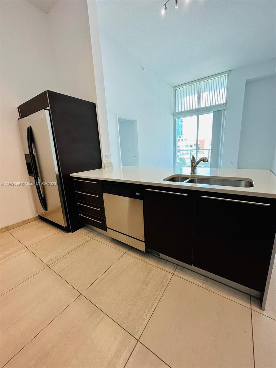 Edgewater Miami, FL 33132 - Photo 12 of 25 a kitchen with a sink and cabinets